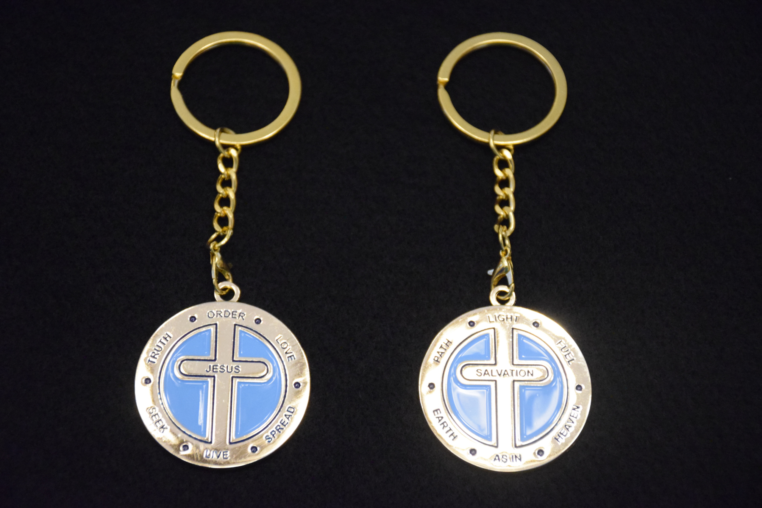 Two key chains with a cross on them.