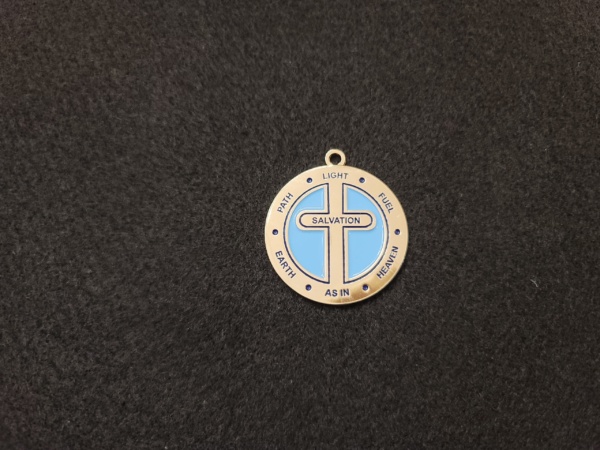 A cross is shown on the front of a medal.